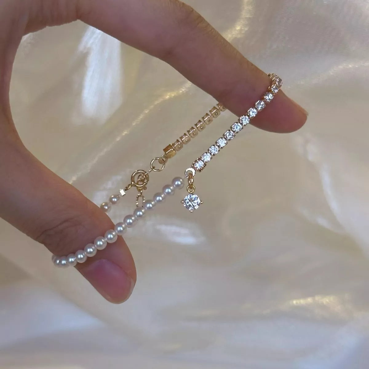 Detail of the pearl strand and dangling accent charm