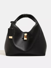 Front view of black pebbled handbag with gold-tone turn-lock clasp