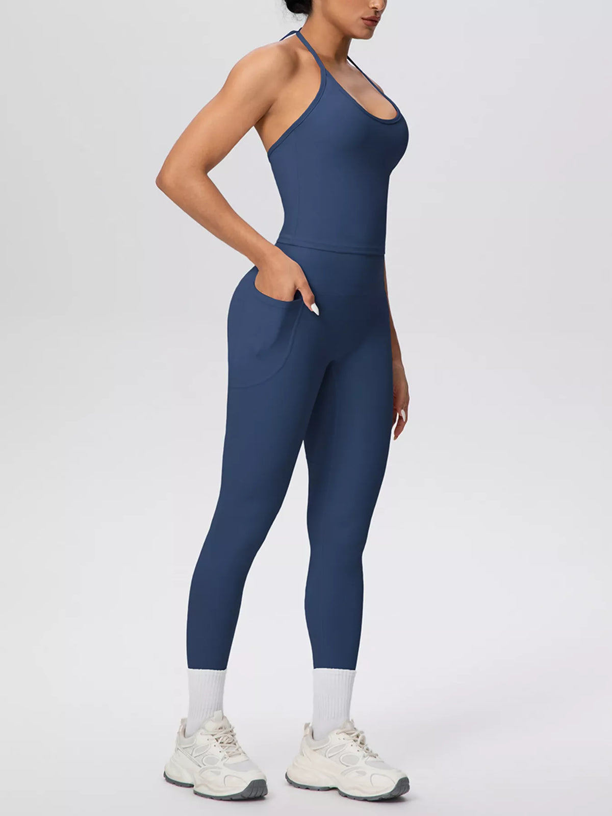 Back view showing fit of halter neck cami and high-waisted leggings active set