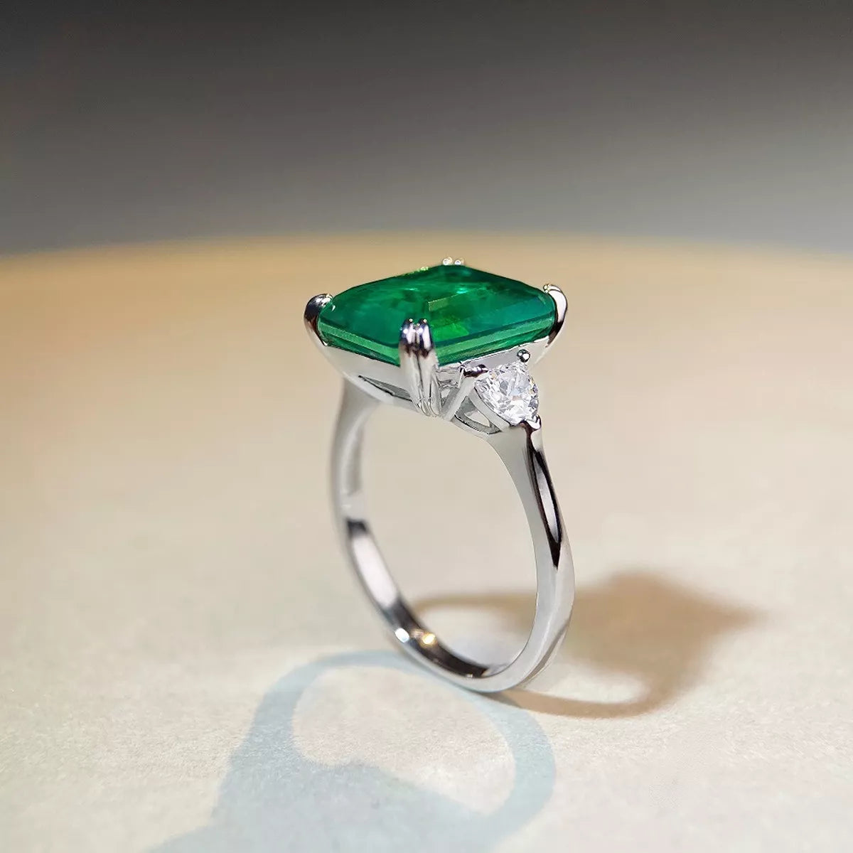 Green rectangular zircon ring photographed from above.