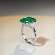 Green rectangular zircon ring photographed from above.