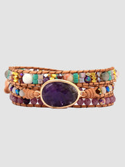 Front product view of the triple-layer beaded bracelet with purple oval stone.