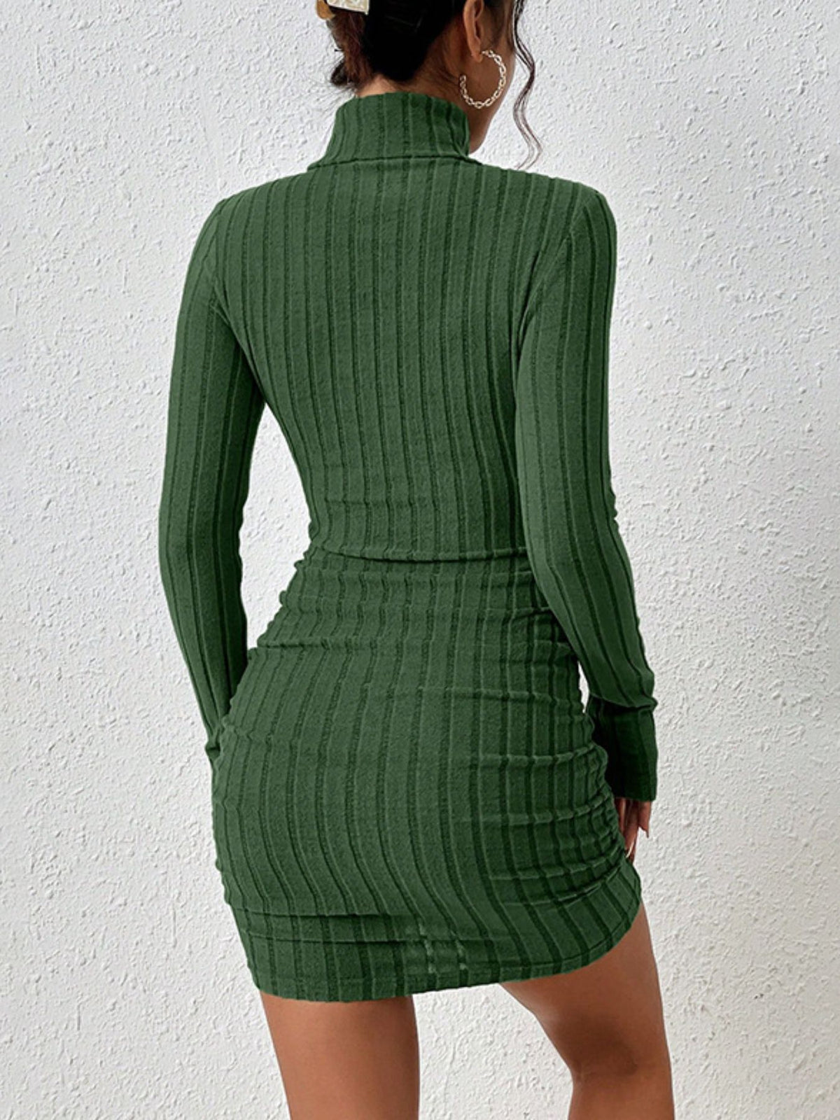 Back view of green dress worn by model