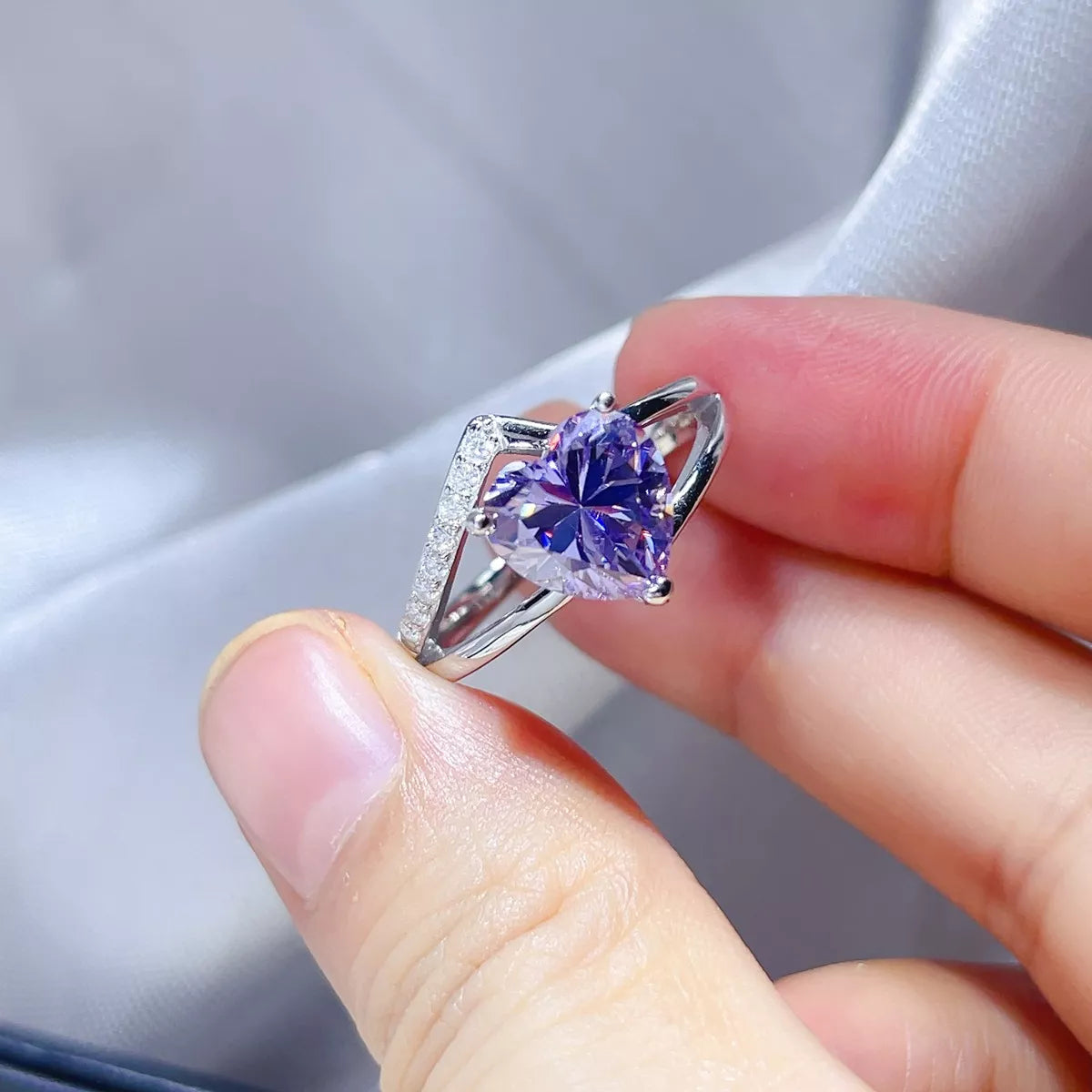 Sterling silver ring with blue-purple moissanite displayed from above