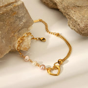 Gold heart and pearl bracelet displayed flat