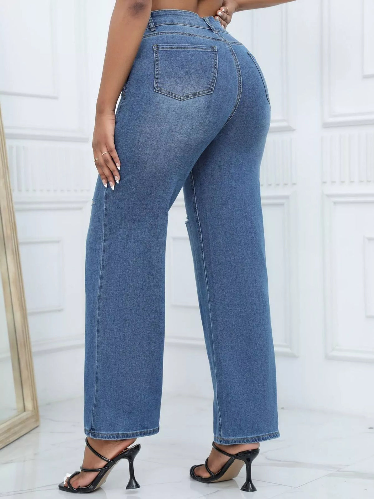 Back view of medium-blue wide-leg jeans with rear pockets