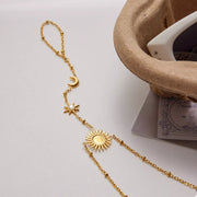 Close-up of the sun motif and fine chain links