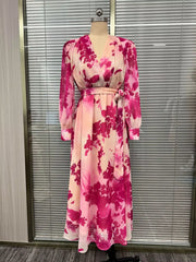 Pink floral long-sleeve maxi dress displayed from the front on a dress form.