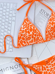Leopard-print bikini with neon-green side ties