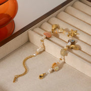 Close view of shell pendant and gold chain links