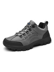 Grey and black low-top lace-up shoe shown against white