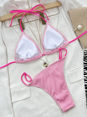 Pink bikini laid flat with the white cup lining and hot pink ties visible