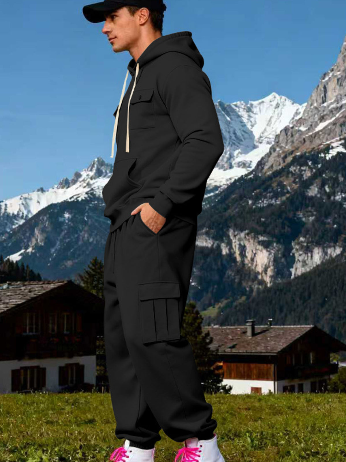 Side view of black hoodie and cuffed cargo joggers showing the thigh flap pocket