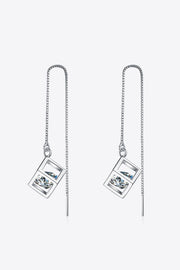 Silver-tone threader earrings hanging in loops with open square settings