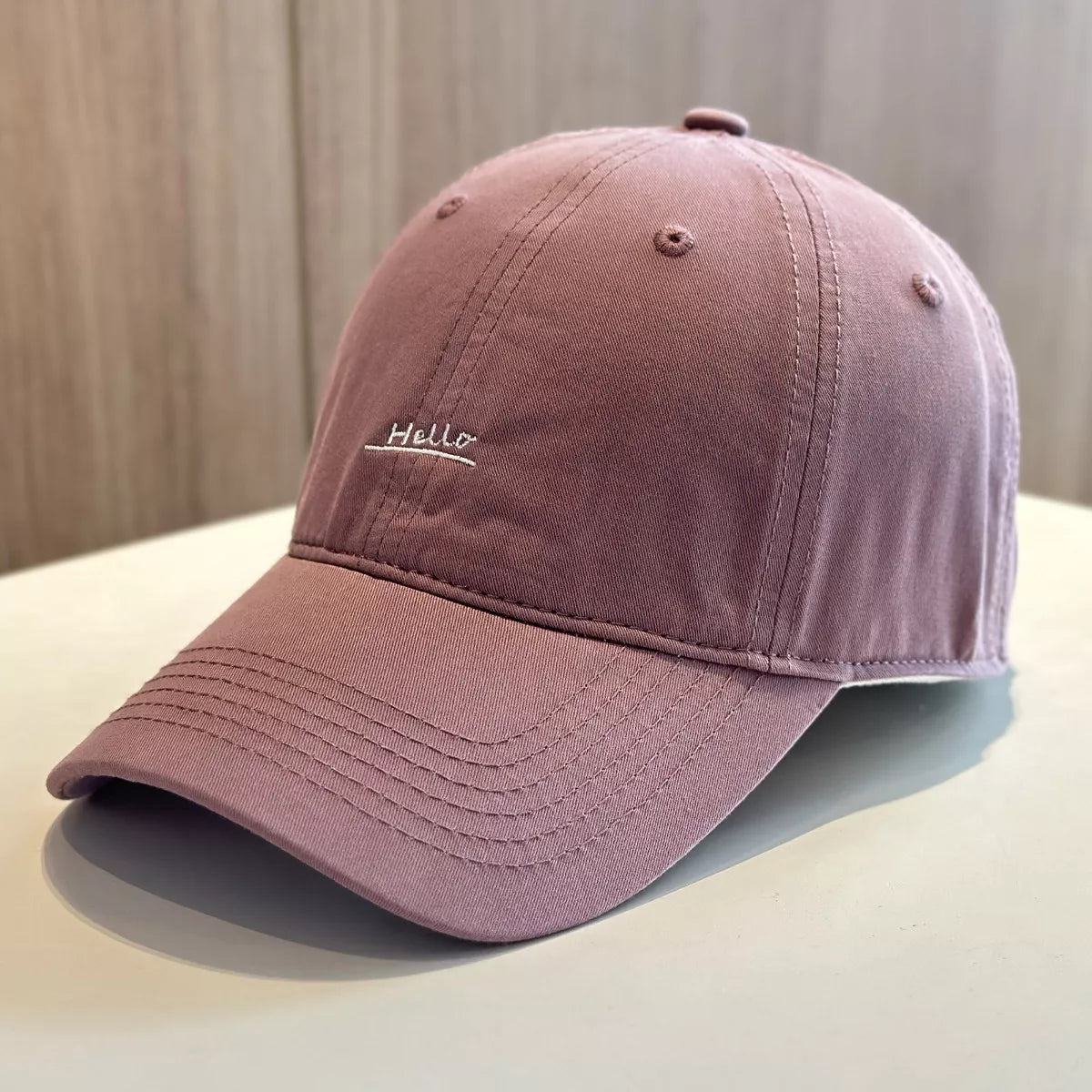 Purple cotton baseball cap with small Hello embroidery on front