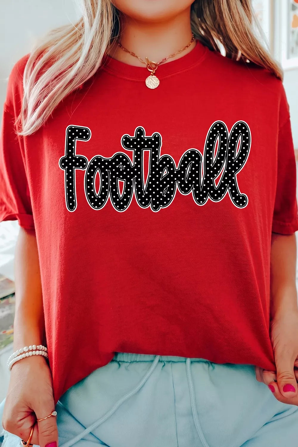Close view of football lettering on red T-shirt