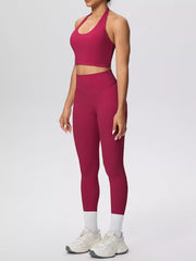 Side view of burgundy halter crop top and high-waisted leggings