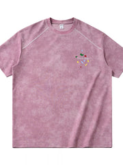 Front view of washed pink T-shirt with small chest graphic