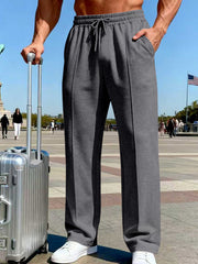 Front view of charcoal gray drawstring pants with a white shirt and Eiffel Tower backdrop.