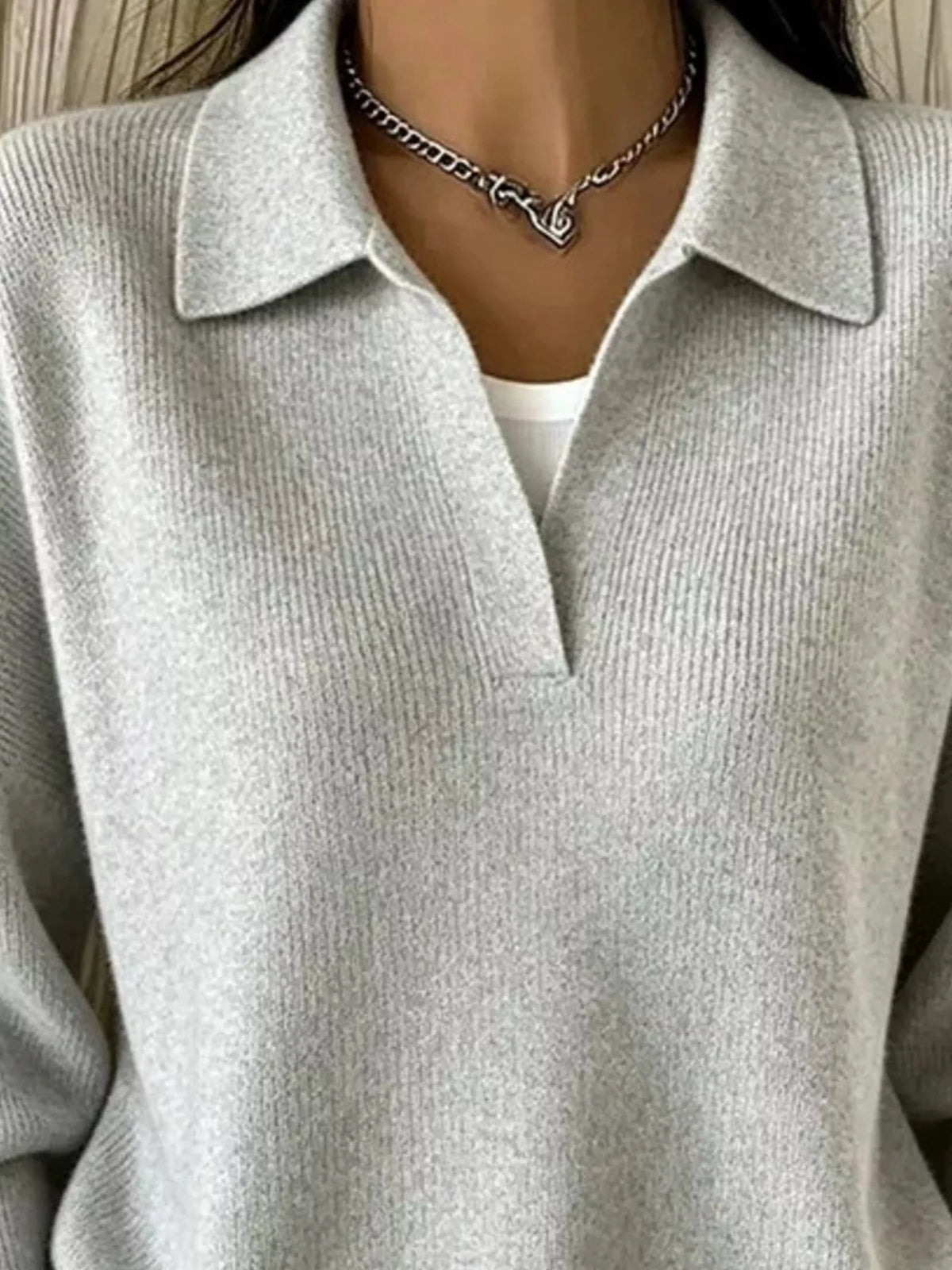 Light gray ribbed polo sweater close-up of collar and ribbed knit