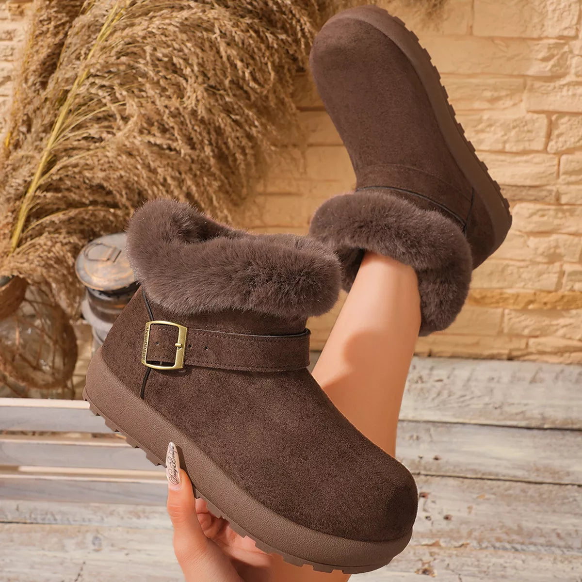 Close view of plush fur cuff and buckle on tan boot
