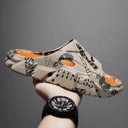Beige printed platform slide held at an angle showing side ventilation and orange footbed