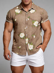 Model wearing a taupe floral short-sleeve shirt