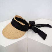 Straw visor with black ribbon tied at the back, side view