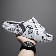 White graphic-print open-toe platform slide with oval side opening, held in a hand