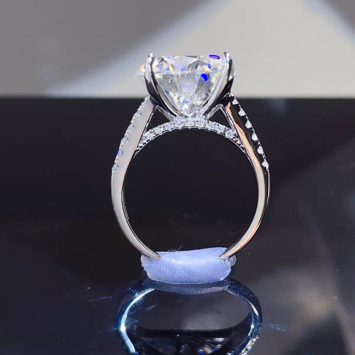 Side view showing the raised setting and band of the moissanite ring