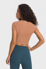 Back view of peach cropped T-shirt with teal leggings