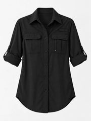 Black button-down shirt laid flat with chest pockets and rolled sleeves