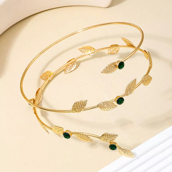 Gold-tone leaf bracelet with dark green and clear stone accents arranged in a loop