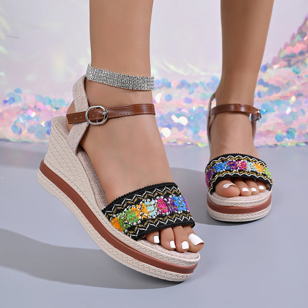 Front view of beige wedge sandals with colorful embroidered toe straps