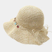 Rear view of beige straw-woven sun hat with tie at the crown