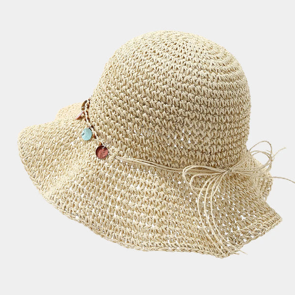 Rear view of beige straw-woven sun hat with tie at the crown