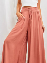 Close view of draped rose wide-leg pants and elastic waist