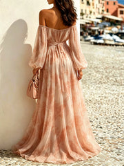 Rear view of the peach maxi dress showing the low off-shoulder neckline and tied waist