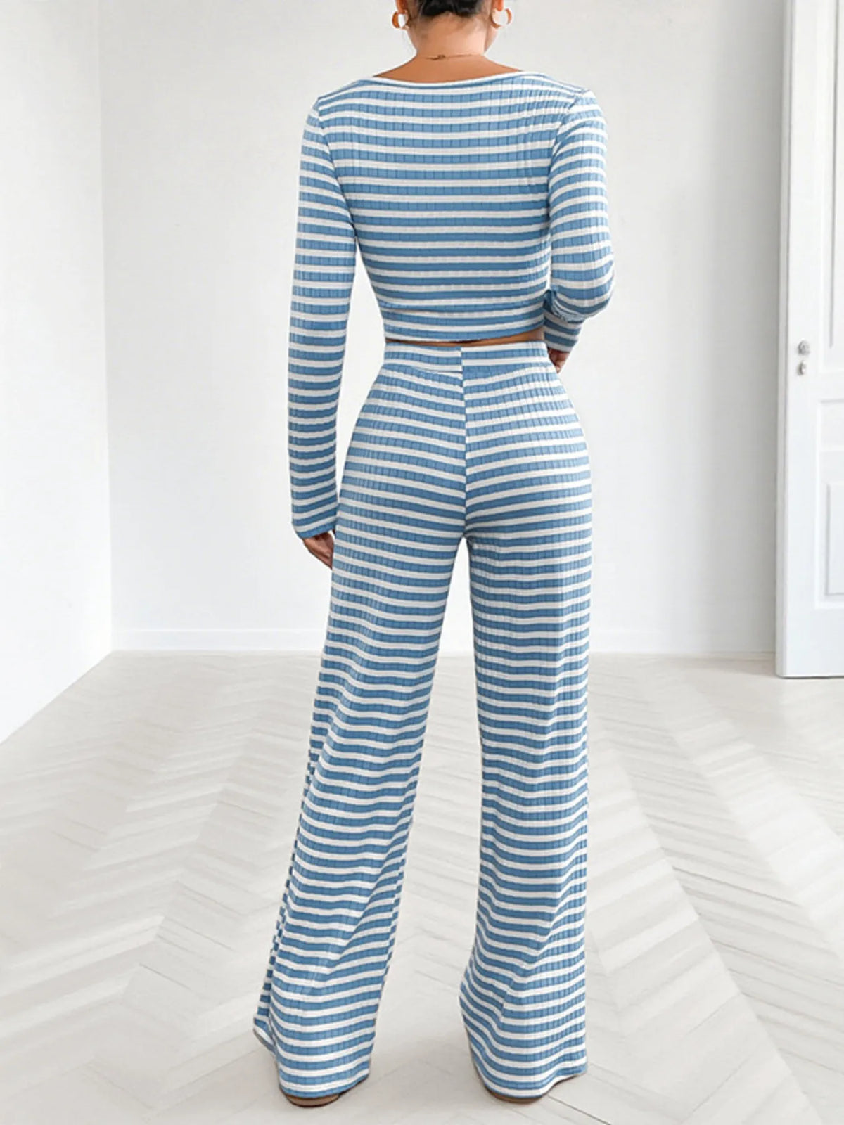 Back view of model in striped square-neck top and wide-leg pants