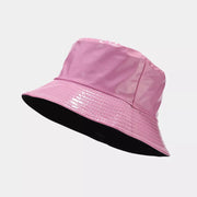 Glossy pink bucket hat with black underside, shown at an angle
