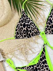 Neon-green and leopard-print bikini set laid flat with straw hat