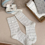 White knit socks displayed flat with textured stripe details