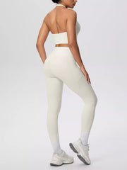 Back view of white halter top and high-waisted leggings