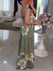 Front view showing the strapless neckline and tiered skirt of the green floral maxi dress.