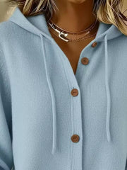 Close view of light blue knit cardigan hood, drawstrings and brown buttons