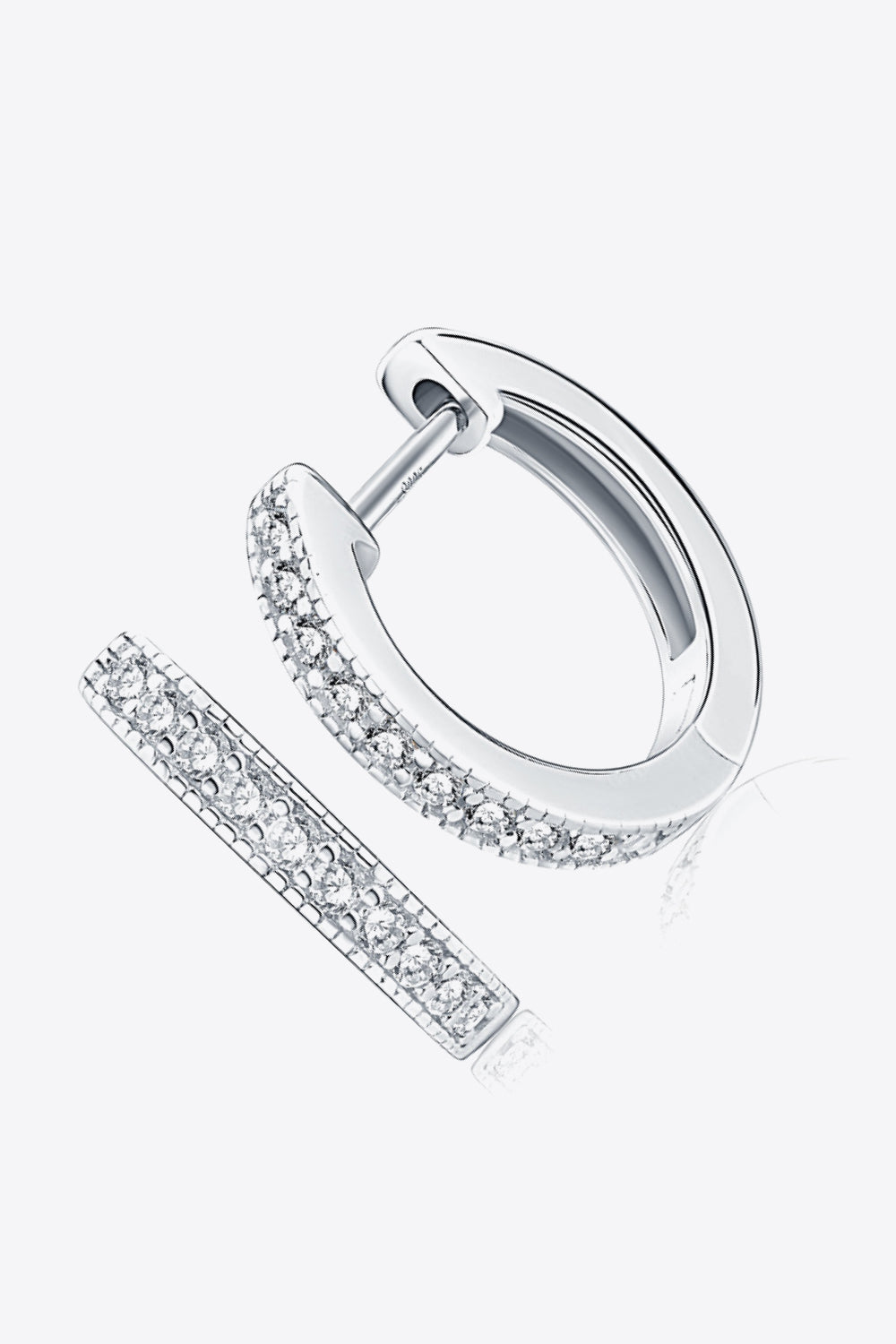 Angled view of slim silver hoops with rows of clear stones along the front edge