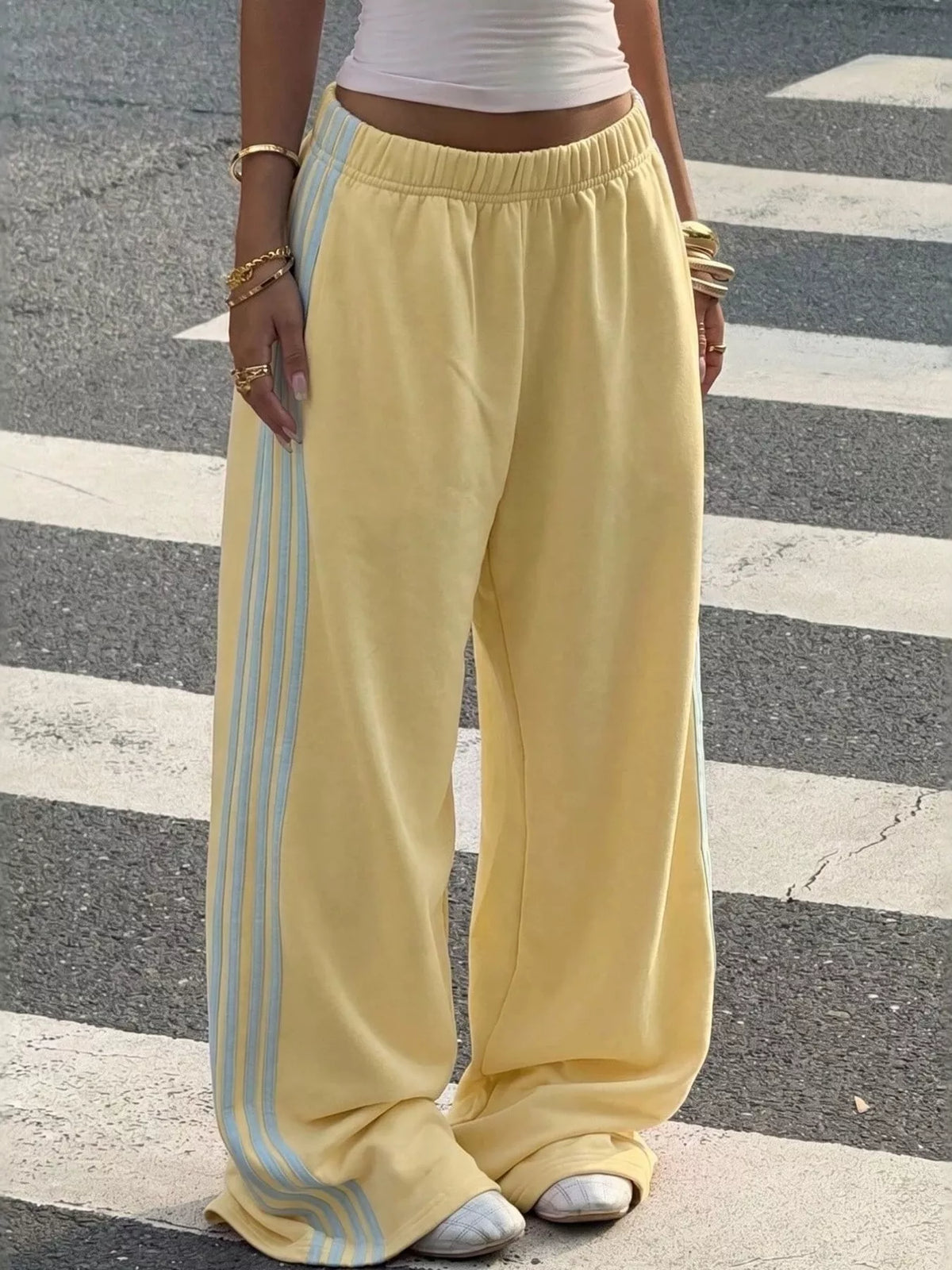 Yellow wide-leg track pants with pale side stripes