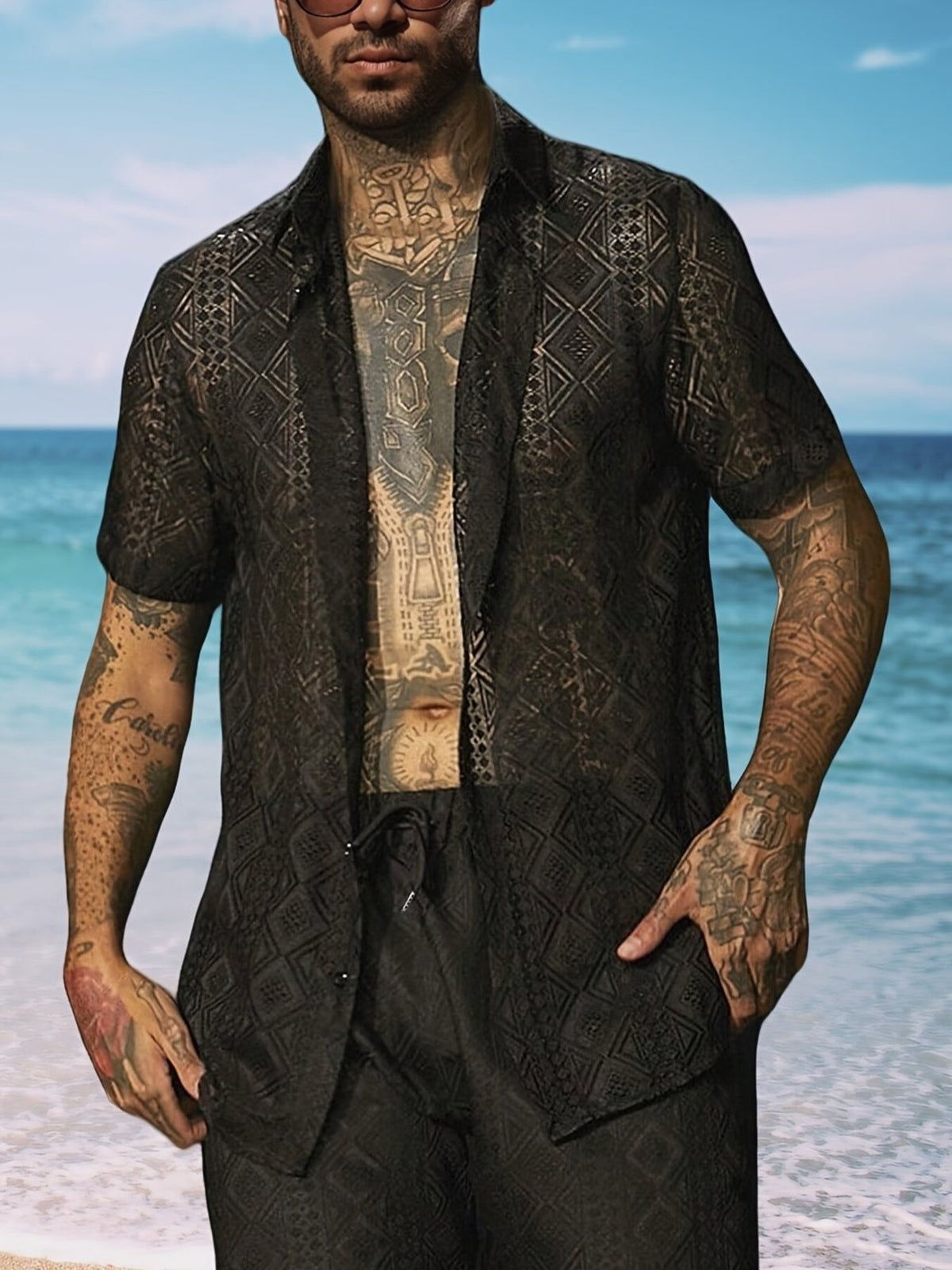 Model wearing a dark geometric-print short-sleeve button-up shirt
