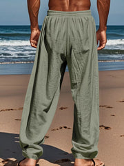 Rear view of sage green pants on a beach