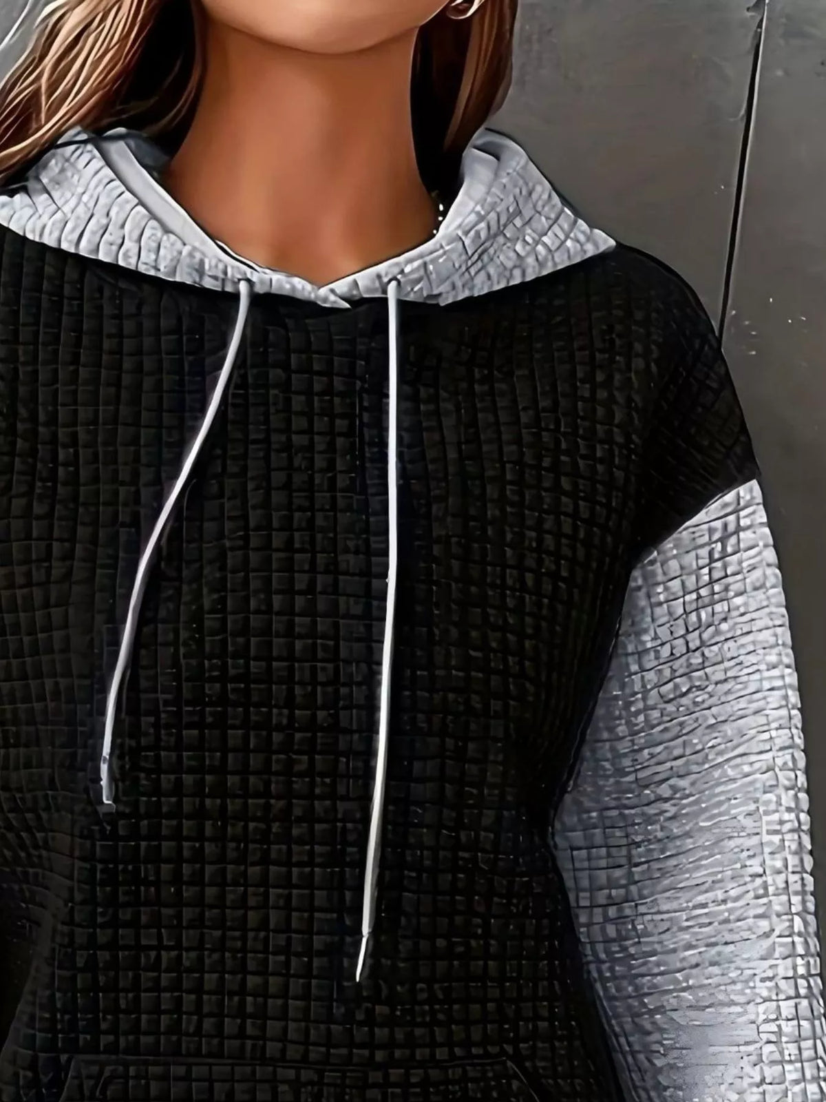 Front view of black and white color-block hooded top